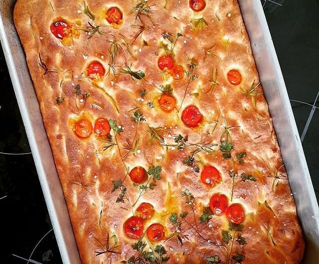Focaccia with parsley, cherry tomatoes and rosemary
